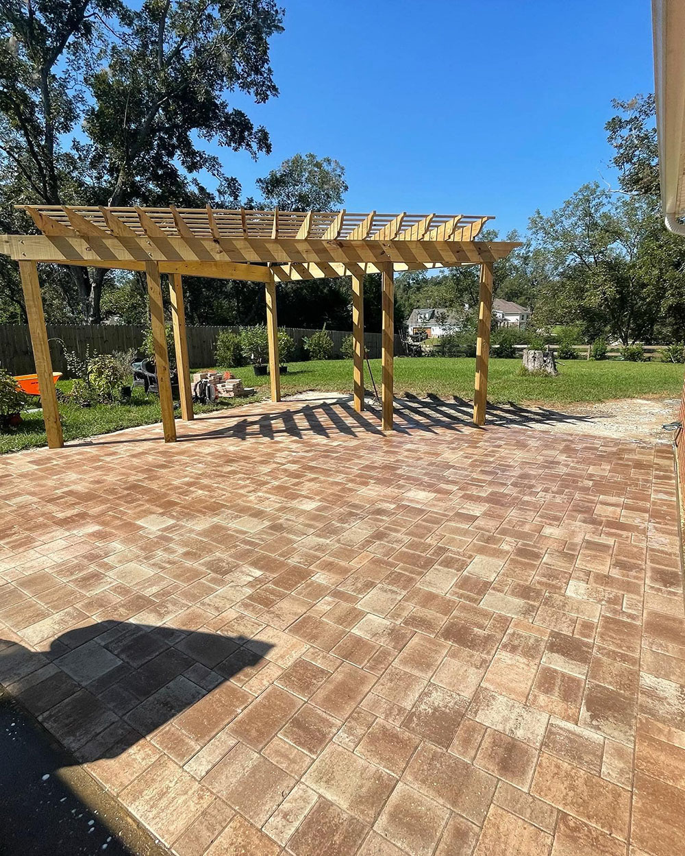 Workers install pavers at a job site in Baldwin County, Alabama.